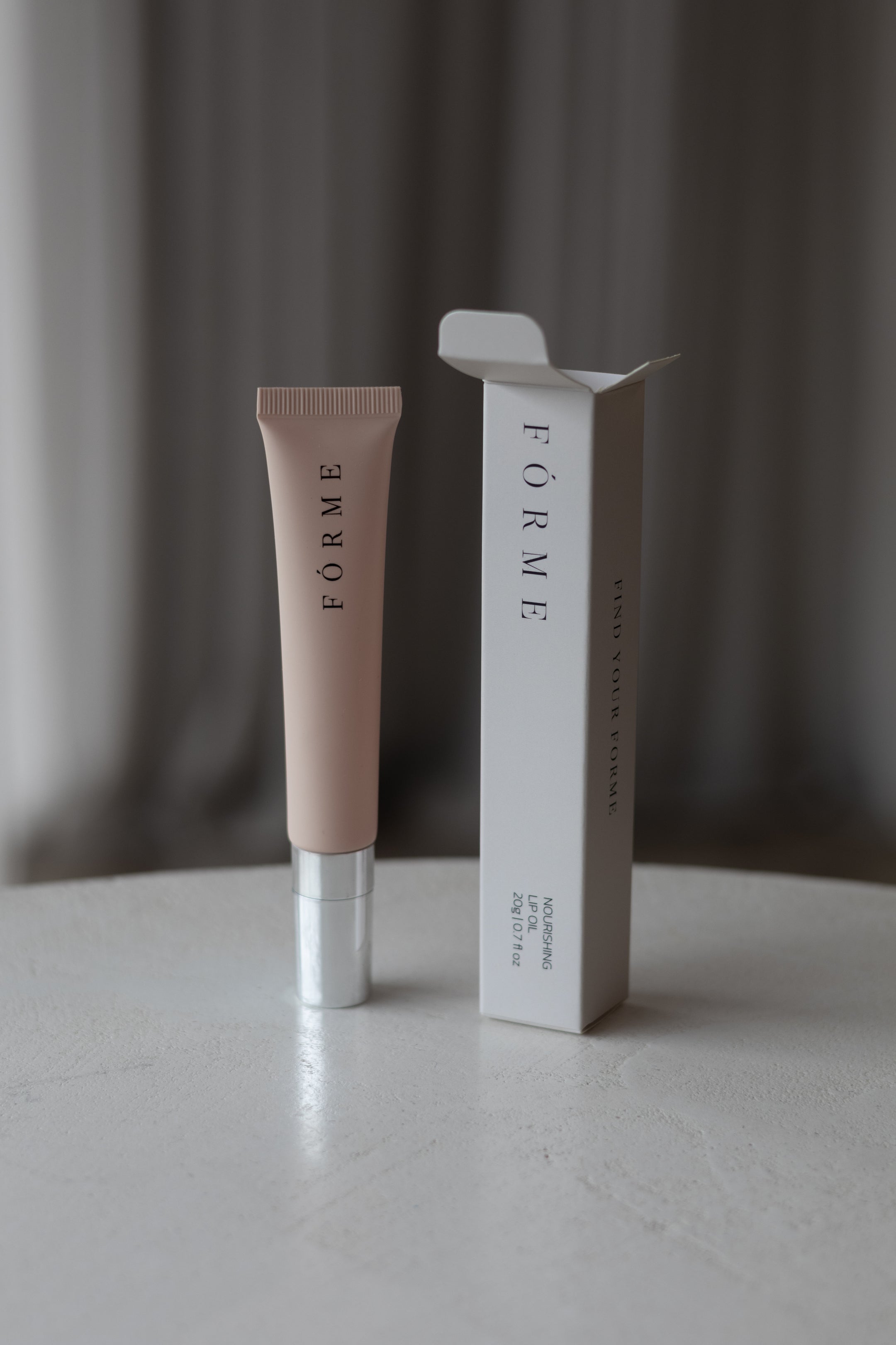 Forme Essentials Nourishing Lip Oil — hydrating lip oil infused with coconut essence for a glossy finish.